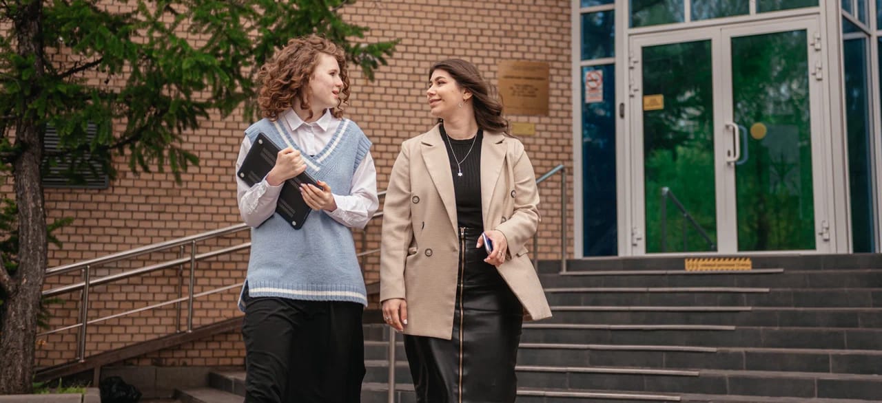 two women chatting on campus